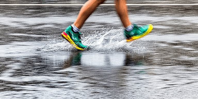 u1221652487 A runner splashing through a puddle during a ligh 7d503f9e e33a 4753 9c0e 97cf6346dafc 1 768x384